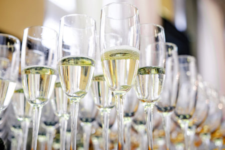Close-up of champagne flutes filled with bubbly champagne, neatly arranged for a formal event....