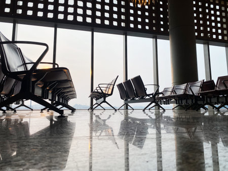 Modern airport waiting room with sleek seating, large windows providing a view, and a polished...