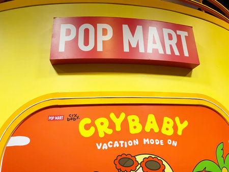 Pattaya, Thailand - November 20, 2025: Pop Mart store features bright yellow walls and colorful Crybaby vacation artwork, creating a cheerful shopping atmosphereのeditorial素材