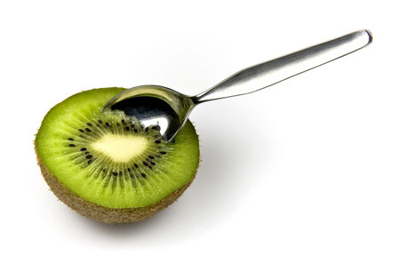 Kiwi tropical fruit and spoon isolated on white backgroundの写真素材