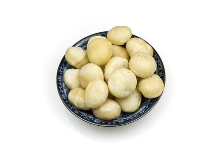 Salted macadamia nuts on serving plateの写真素材