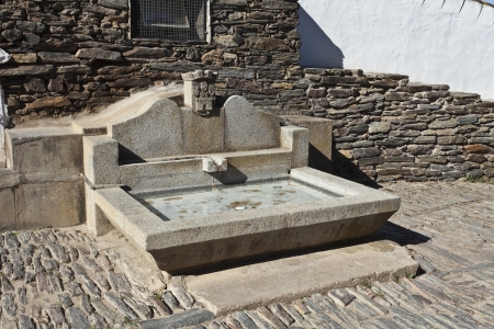 Monsaraz, stone made fountain at the entry of the fortressの写真素材