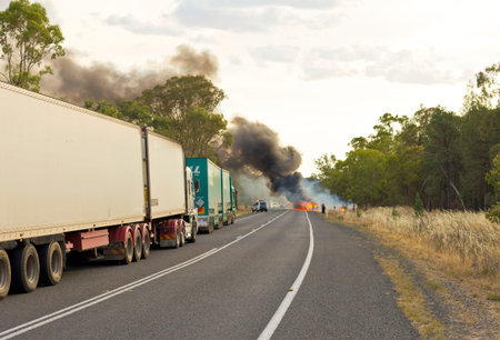 Car on fire on an Australian highway during a very hot summer day