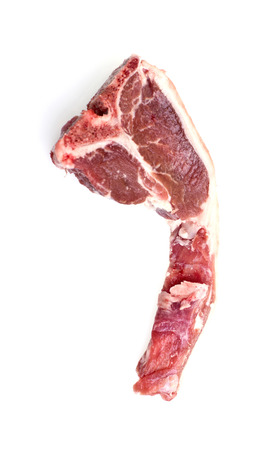 Single raw lamb loin chop with fat around the meat isolated over white background.の写真素材