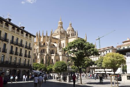 Tourists and locals alike enjoying life in Plaza Mayor and the Gothic Cathedral of Segovia, Spainのeditorial素材