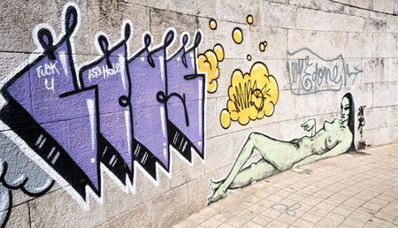 Example of a mixture of Street Art and Graffiti on a non-authorized public wall in Portugal. No release because the artists are unknown.の写真素材