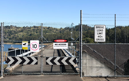 View of a shut gate and multiple warning signs