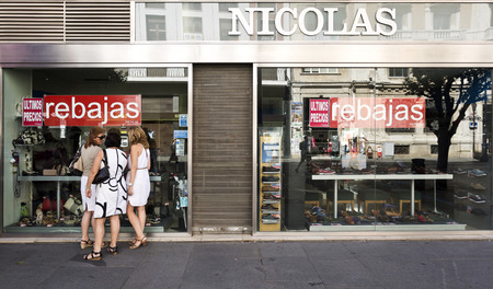 Three unidentified women discussing shoes. Shoes are the second girl's best friend rapidly overtaking diamondsのeditorial素材