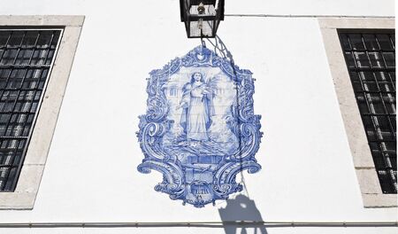 a tile panel with an image of Santa Luzia by an unknown author on the outside wall of the church of Santa Luzia in Lisbon, Portugalの写真素材