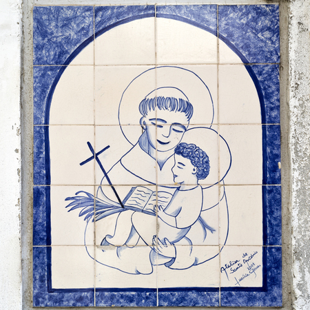 Tile panes with the image Saint Anthony, the patron saint of Lisbon, can be found on the streets of Lisbon, Portugalのeditorial素材