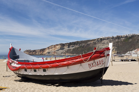 View of colourful fishing boats on the beach of the fishing village of Nazare, Portugalのeditorial素材