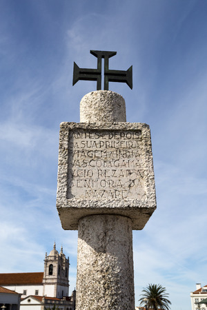 Limestone memory pillar with inscription and Order of Christ Cross located on the hilltop O Sitio overlooking Nazare, Portugal.の写真素材