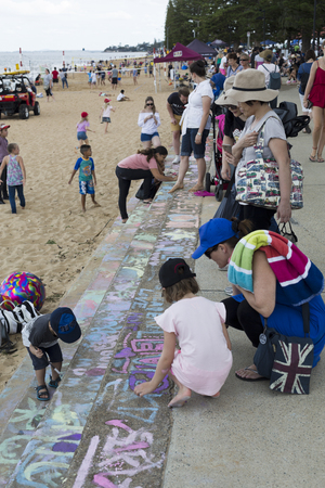 Kids painting on the stairs of Suttons Beach during the Redcliffe Festival of Sails, an annual event which takes place on Good Friday, Queenslandのeditorial素材