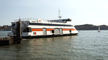 Ferry boat carrying vehicles and passengers departing the Belem Ferry Terminal in Belem Lisbon, Portugalのeditorial素材