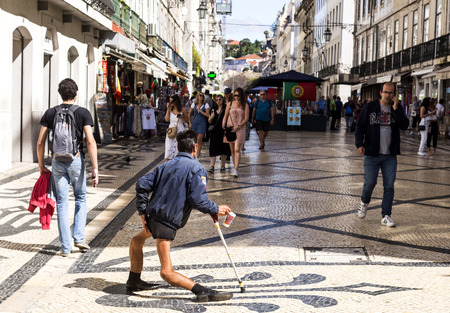 Shocking image of a disabled man begging on the streets of Lisbon, Portugalのeditorial素材