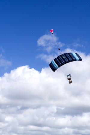 Tandem skydive is the awesome rush of exhilarating freefall after leaping out of a plane to land on the beach, in Queensland, Australiaの写真素材