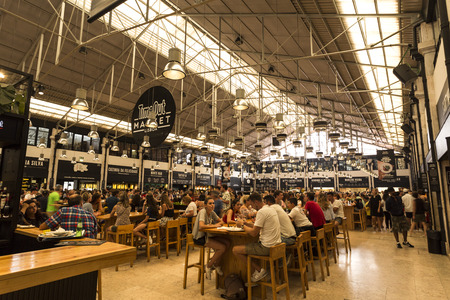 People enjoying eating at the newest and trendy food hall of Time Out Market, in downtown Lisbon, Portugalのeditorial素材