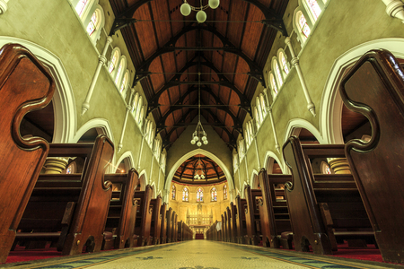 View of the stunning interior and superb cedar pews of Saints Mary and Joseph, a Catholic Cathedral built in 1912 in the Federation Gothic Revival style in Armidale, NSW, Australiaのeditorial素材