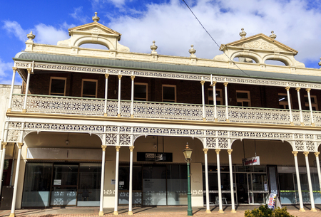 Detail of the heritage listed Imperial Hotel built in 1889 and ornamented with cast-iron friezework,  bullnose awnings and parapets with Grecian urns and pediments on arches, in Armidale, NSW, Australiaのeditorial素材