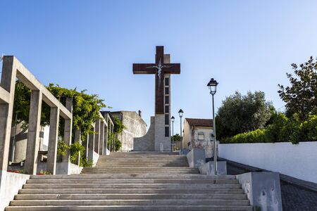Huge steel cross on top of the staircase in Vila Nova de Poiares, Coimbra, Portugalの写真素材
