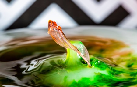A water drop rebounding from a pool of water to create a beautiful imageの写真素材