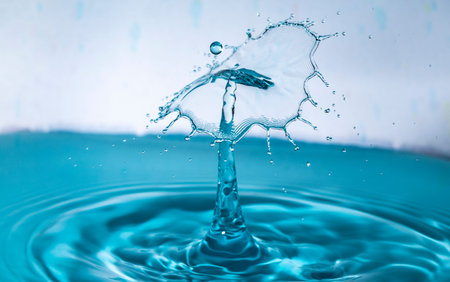 Blue water drop collision creating an umbrellaの写真素材