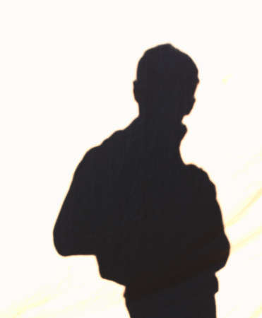 Silhouette of a man on a natural fabric の写真素材