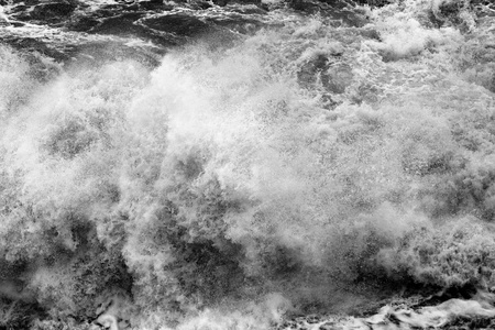 Black and white crashing waves at the sea in stormの写真素材