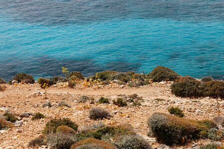 Vibrancy of the golden coast and turquoise transparent waters of Mediterranean seaの写真素材