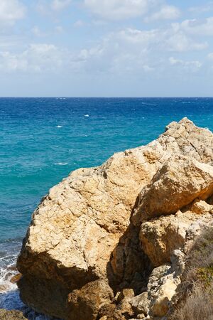 Rocky seashore of the island Gozo in Malta in the middle of mediterranean sea with vivid colors of stones and waterの写真素材
