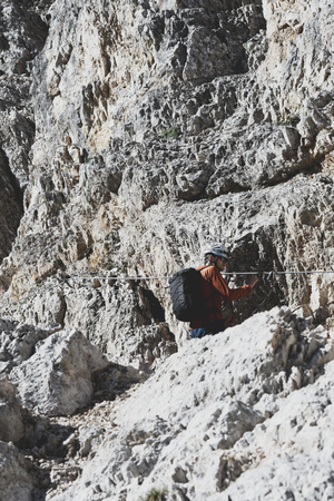 Climber ascending the via ferrata in the Dolomitesの写真素材