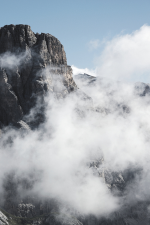 Foggy and cloudy mountains scenery in the Alpsの写真素材