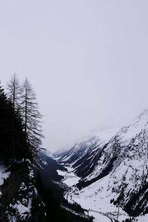 Misty mountain ranges in Pitztal valley with snow covered landscapesの写真素材