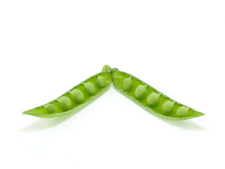 background of open green pea fruit showing seedsの写真素材