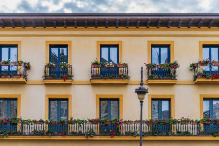 Building with colorful plants on the balconies in the city of Leon in Spainの写真素材