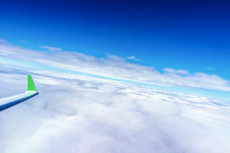 Airplane on flight above the cloudsの写真素材