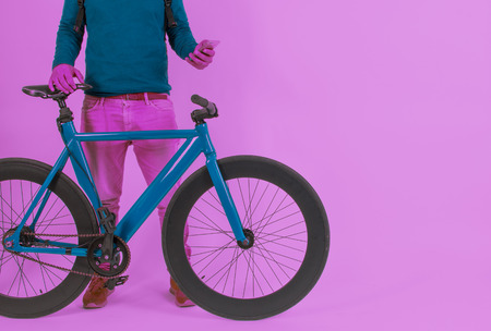 Retro Vintage Bike in a Pastel Color Background and man with Cellphoneの写真素材