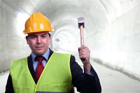 man with construction hat portrait and a hammerの写真素材