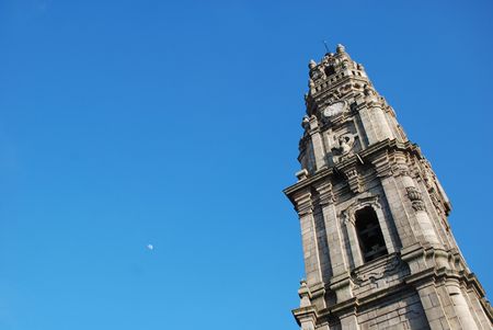 Tower of Clerigos, Portugal, with the moon high behind itの写真素材