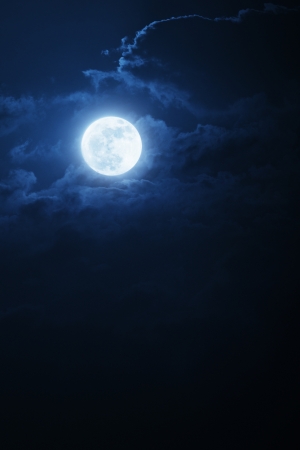 This dramatic photo illustration of a nighttime scene with brightly lit clouds and large, full, Blue Moon would make a great background for many uses This dramatic photo illustration of a nighttime scene with brightly lit clouds and large, full, Blue Moon would make a great background for many uses