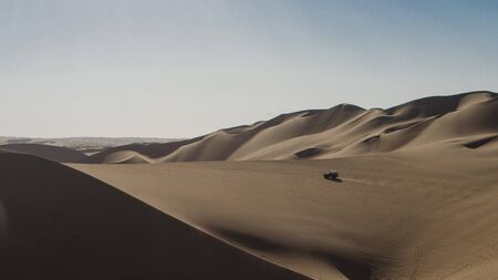 A boogie runing through the dunes of the peruvian desertのeditorial素材