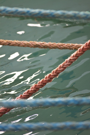 Ropes to the boat with water の写真素材