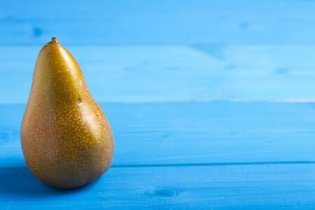 Pear on Blue Wooden Backgroundの写真素材