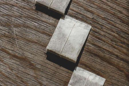 Tea Bags arranged on Wooden Backgroundの写真素材