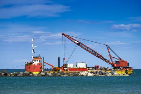 Work in the sea with grab bucketの写真素材