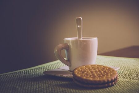 Coffee cup and cookie on the tableの写真素材