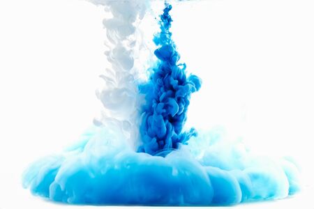 Multicolored swirling drop of ink in water creates abstract backgroundsの写真素材