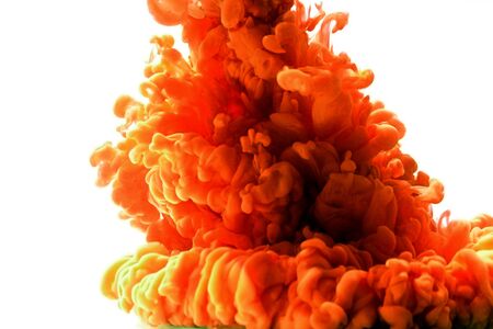 Multicolored swirling drop of ink in water creates abstract backgroundsの写真素材