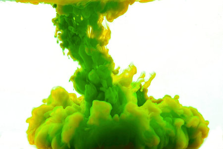 Multicolored swirling drop of ink in water creates abstract backgrounds