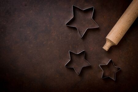 High Angle View Of Cookie Cutters And Rolling Pin On Tableの写真素材